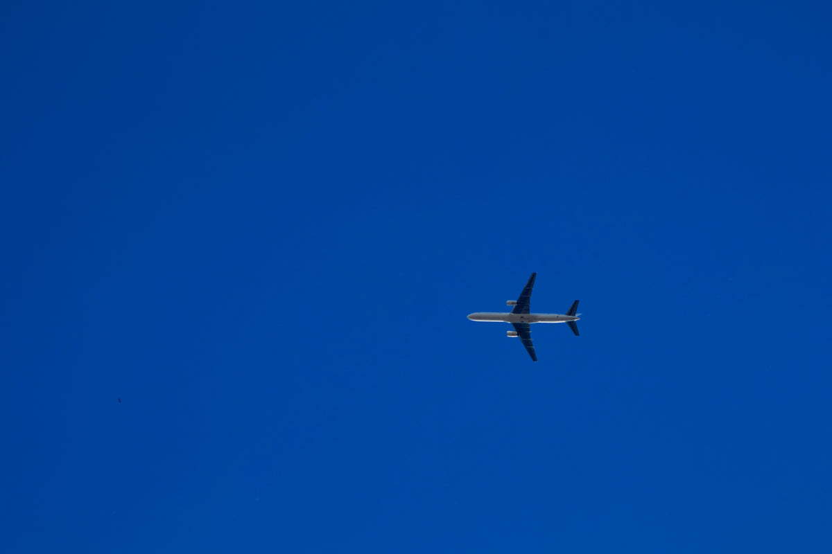 A C-32B Gatekeeper flying against deep blue sky.